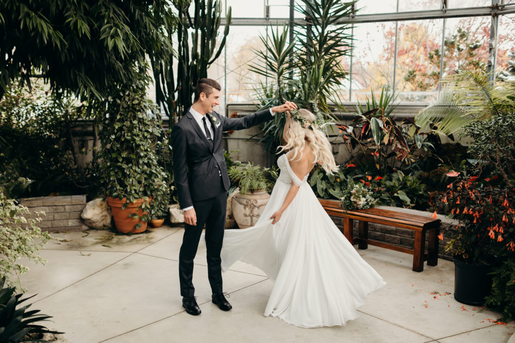 bride and groom dancing in green house in toronto, ontario