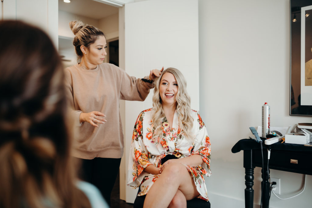 bride having her hair done for intimate wedding in toronto, ontario