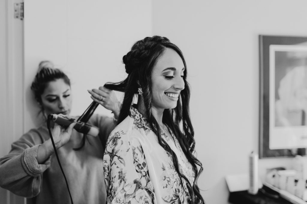 bridesmaid having her hair done for intimate wedding in toronto, ontario