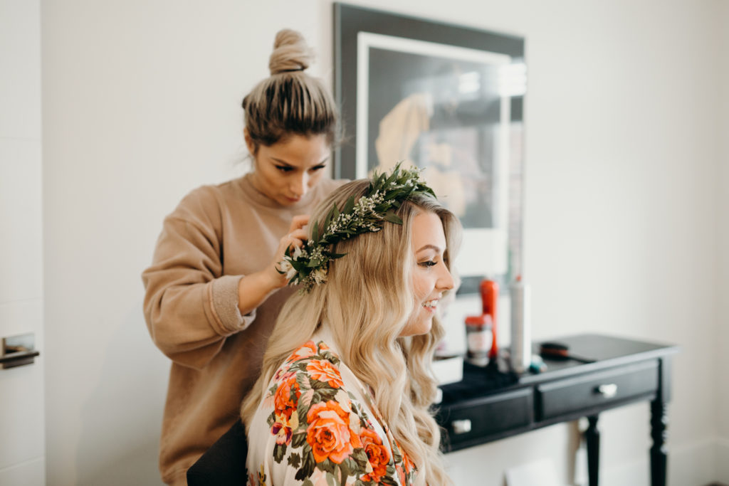 placing flower crown on bride from florist Grow and Bloom in London, Ontario.